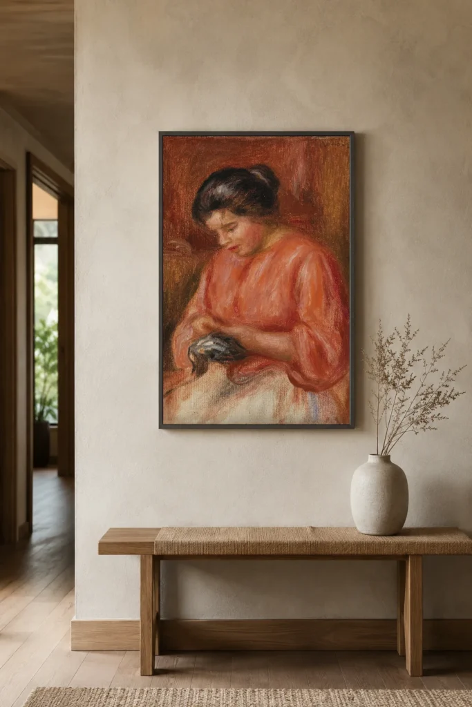 Framed print of Girl Darning hanging on a wall in a furnished room