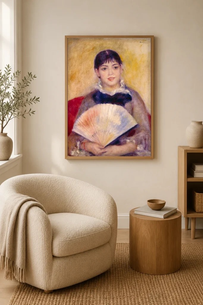 Framed print of Girl with a Fan hanging on a wall in a furnished room