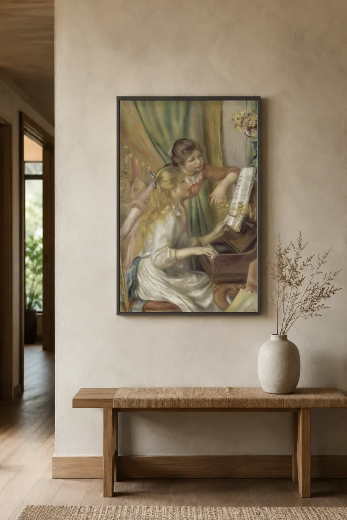 Framed print of Girls at the Piano hanging on a wall in a furnished room