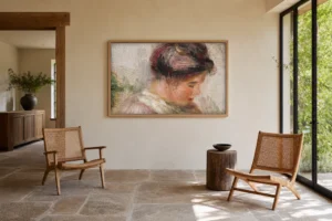 Framed print of Head of Young Girl (Tête de jeune fille) hanging on a wall in a furnished room