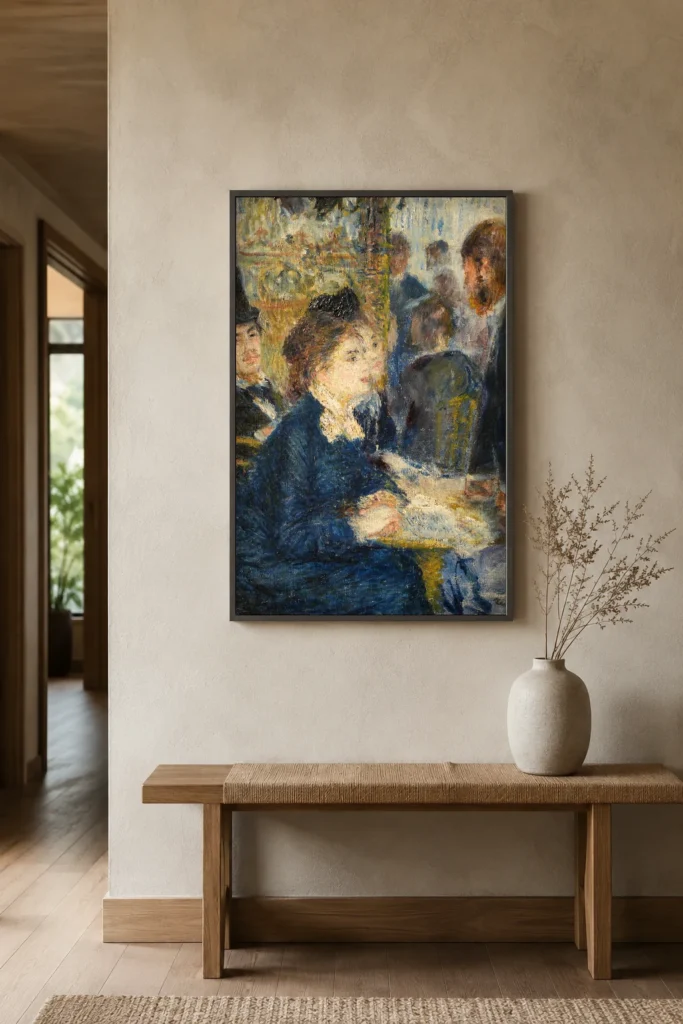 Framed print of In the Café hanging on a wall in a furnished room