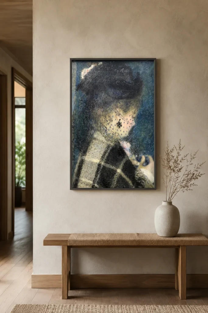 Framed print of Jeune femme à la voilette hanging on a wall in a furnished room