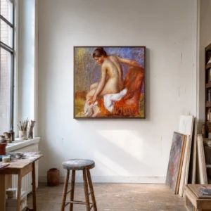 Framed print of Nude in an Armchair hanging on a wall in a furnished room