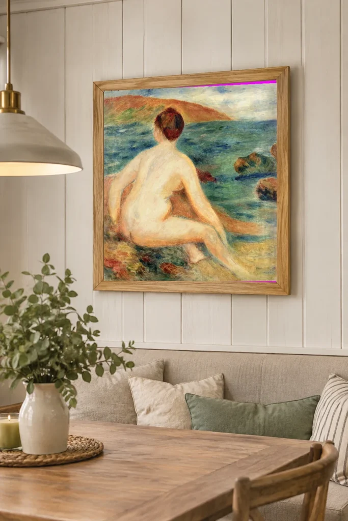 Framed print of Nude Bather Facing the Sea hanging on a wall in a furnished room