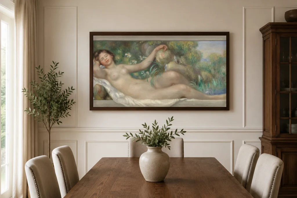 Framed print of Reclining Nude (La Source) hanging on a wall in a furnished room