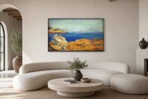 Framed print of Yellow Rocks with Blue Sea hanging on a wall in a furnished room