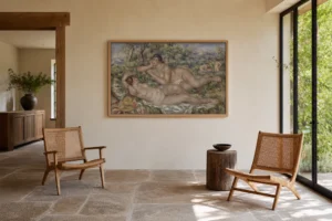 Framed print of The Bathers hanging on a wall in a furnished room