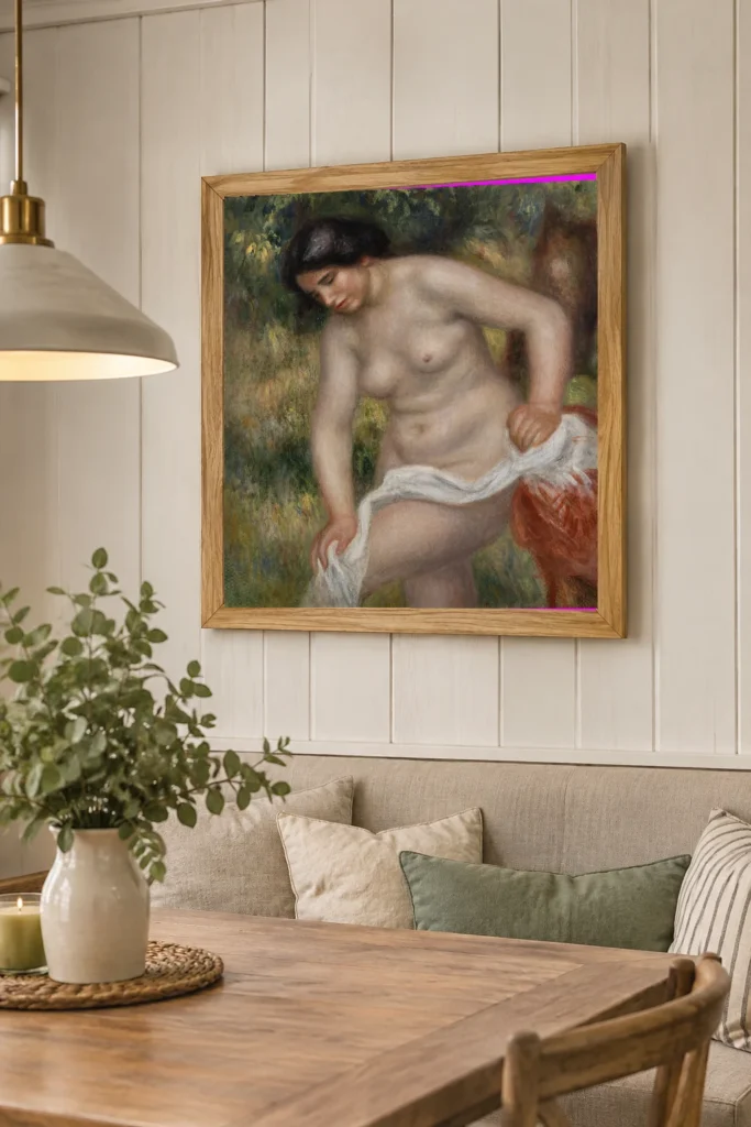 Framed print of Bather Drying Herself (Baigneuse s’essuyant) hanging on a wall in a furnished room