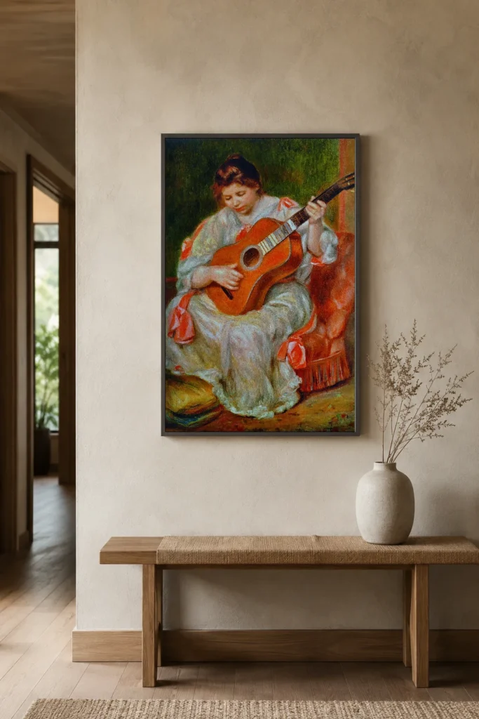 Framed print of Woman Playing a Guitar hanging on a wall in a furnished room