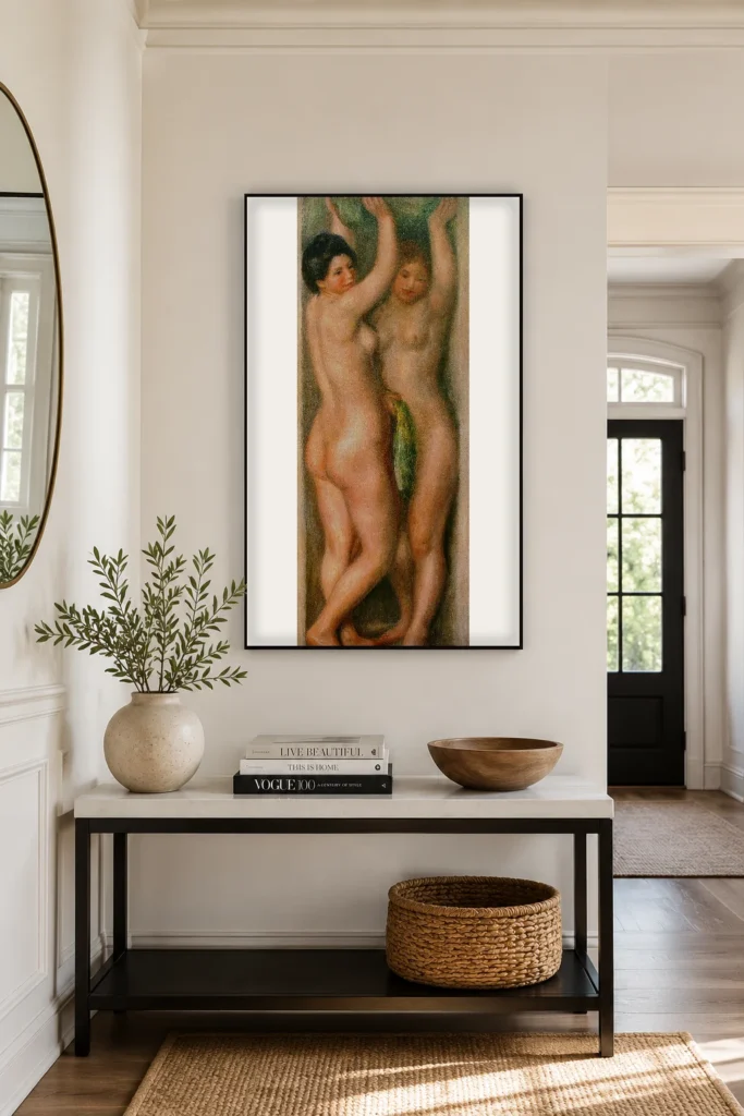 Framed print of two young nude women hanging on a wall in a furnished room