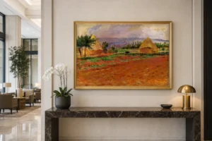 Framed print of Field and Haystacks hanging on a wall in a furnished room