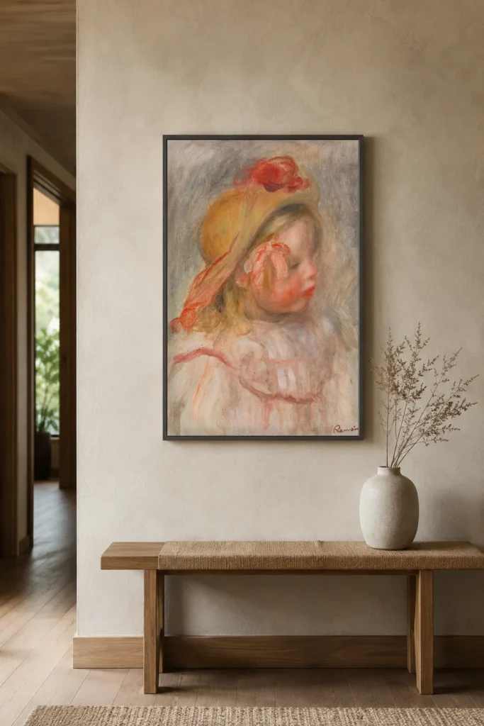 Framed print of Coco in a Straw Hat hanging on a wall in a furnished room