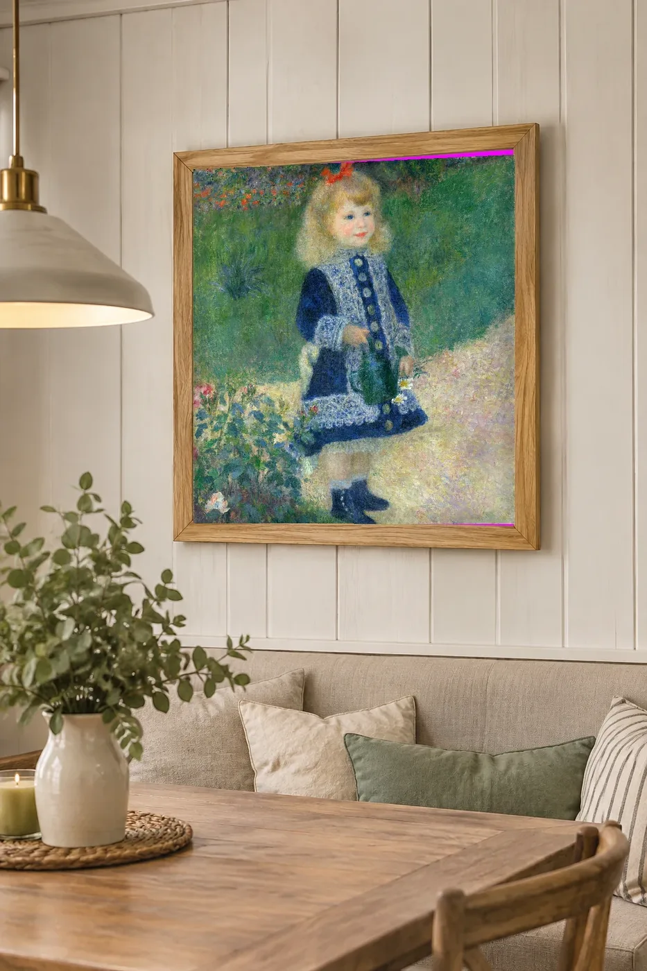 Framed print of A Girl with a Watering Can hanging on a wall in a furnished room