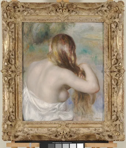 A woman seen from behind braids her long blonde hair, a white cloth draped over her shoulders, in a gilded frame