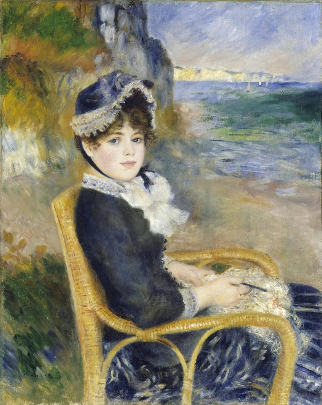 A woman in a dark blue jacket and lace-trimmed bonnet sitting in a wicker chair by the seashore, in navy blue, sandy beige, and sea green