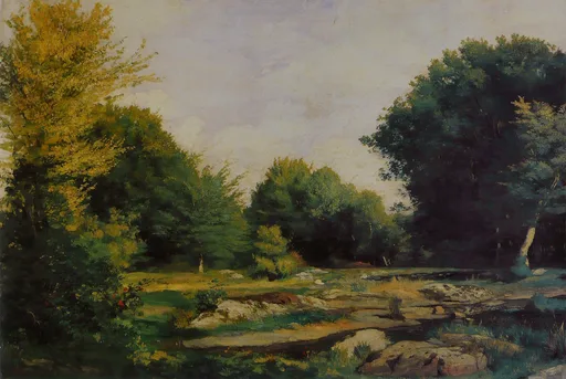 A rocky forest clearing with tall green and golden trees under a pale hazy sky