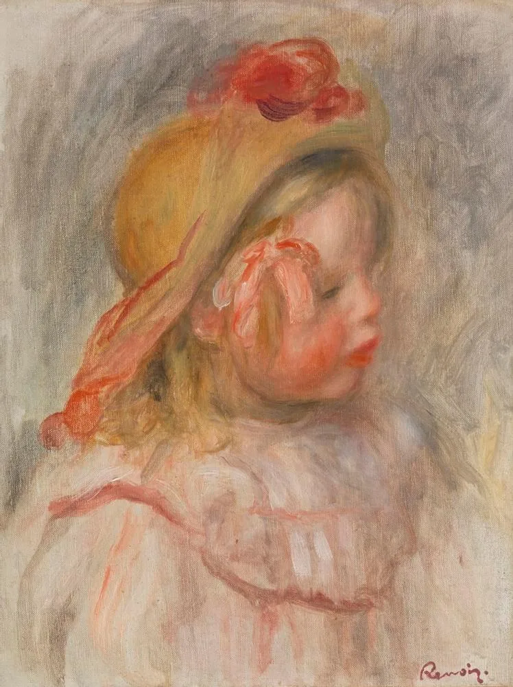 A child wearing a straw hat trimmed with a red flower, in a pink garment against a grey background