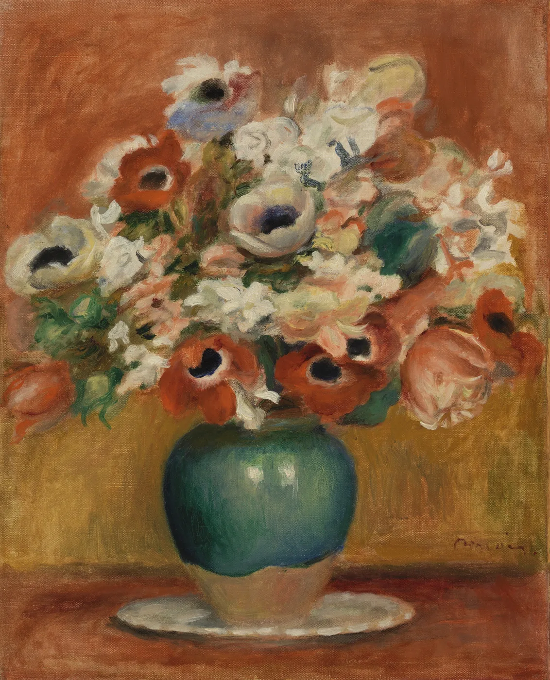 White and orange anemones with dark centres in a round green vase on a saucer, against a warm terracotta background