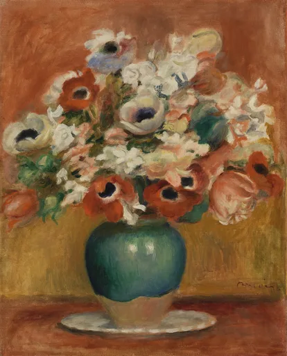 White and orange anemones with dark centres in a round green vase on a saucer, against a warm terracotta background