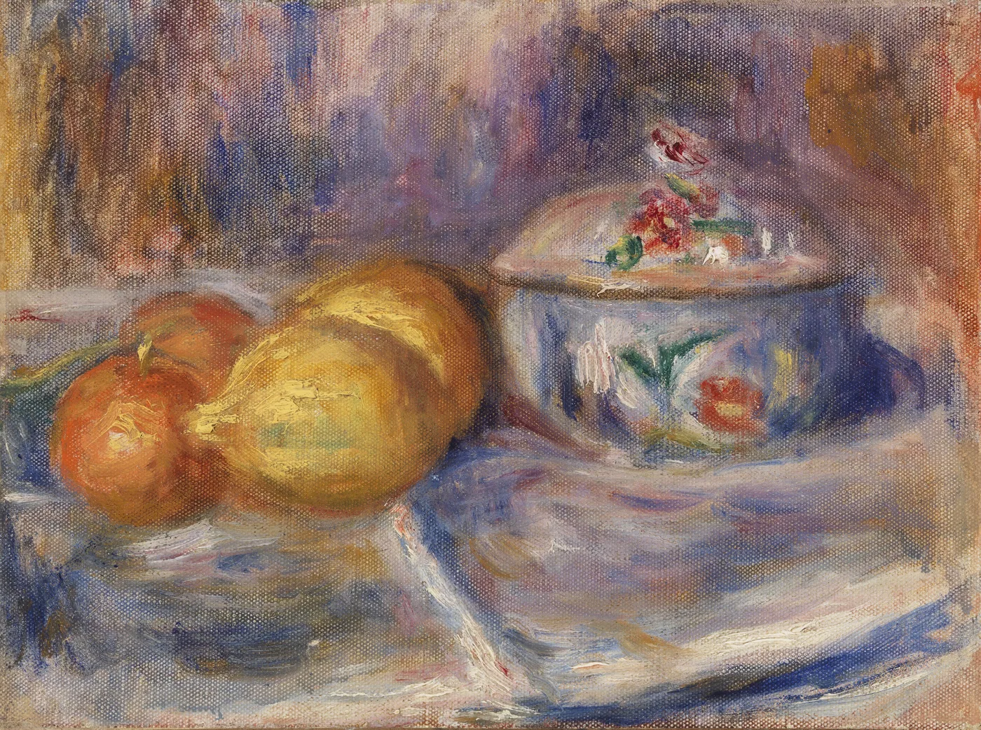 An orange and a yellow pear beside a lidded floral-painted porcelain box on a white cloth, in soft lavender and gold tones