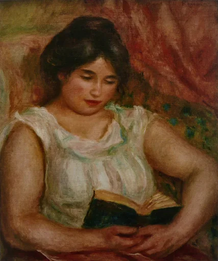 A dark-haired woman in a sleeveless white blouse reading a book, seated against a red patterned backdrop