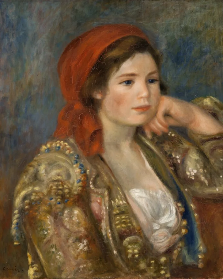 A young woman in an ornate gold-embroidered jacket and red headscarf rests her chin on her hand, white blouse beneath.
