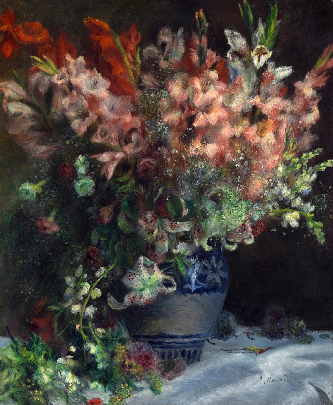 A towering bouquet of pink and red gladioli with white blossoms in a blue and white patterned vase, against a dark background