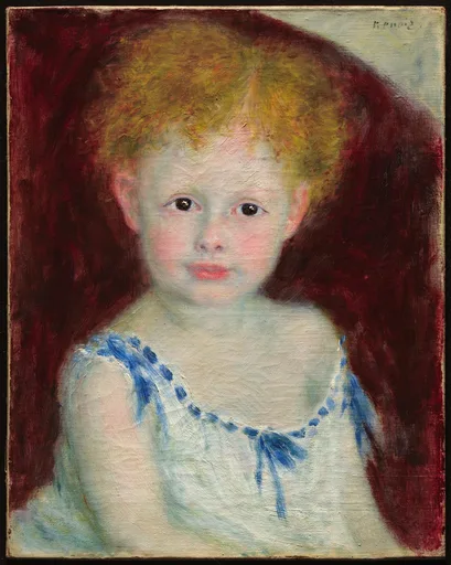 A curly-haired blond child in a white dress trimmed with blue ribbon sits against a deep maroon background.