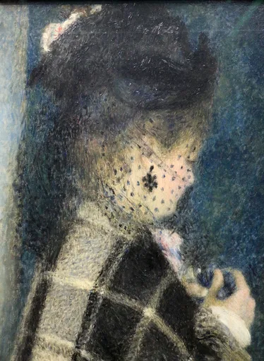 A young woman's face veiled behind a spotted black net, dark hair and dark clothing set against a deep blue background