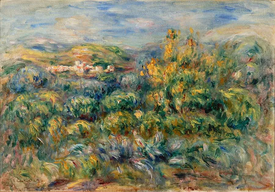 A hilly Cagnes landscape with a distant hillside village, framed by dense green and gold flowering shrubs under a blue sky.