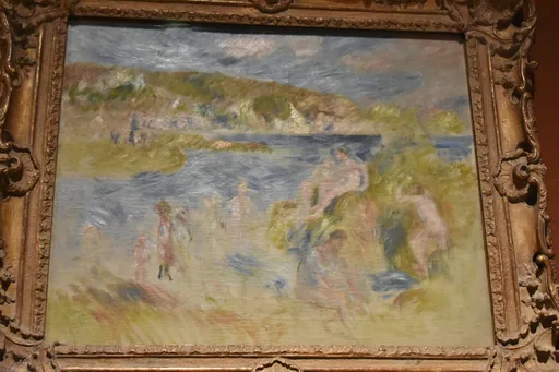 Nude bathers gather on a grassy shore beside a blue-grey bay, hills rising under a cloudy sky.