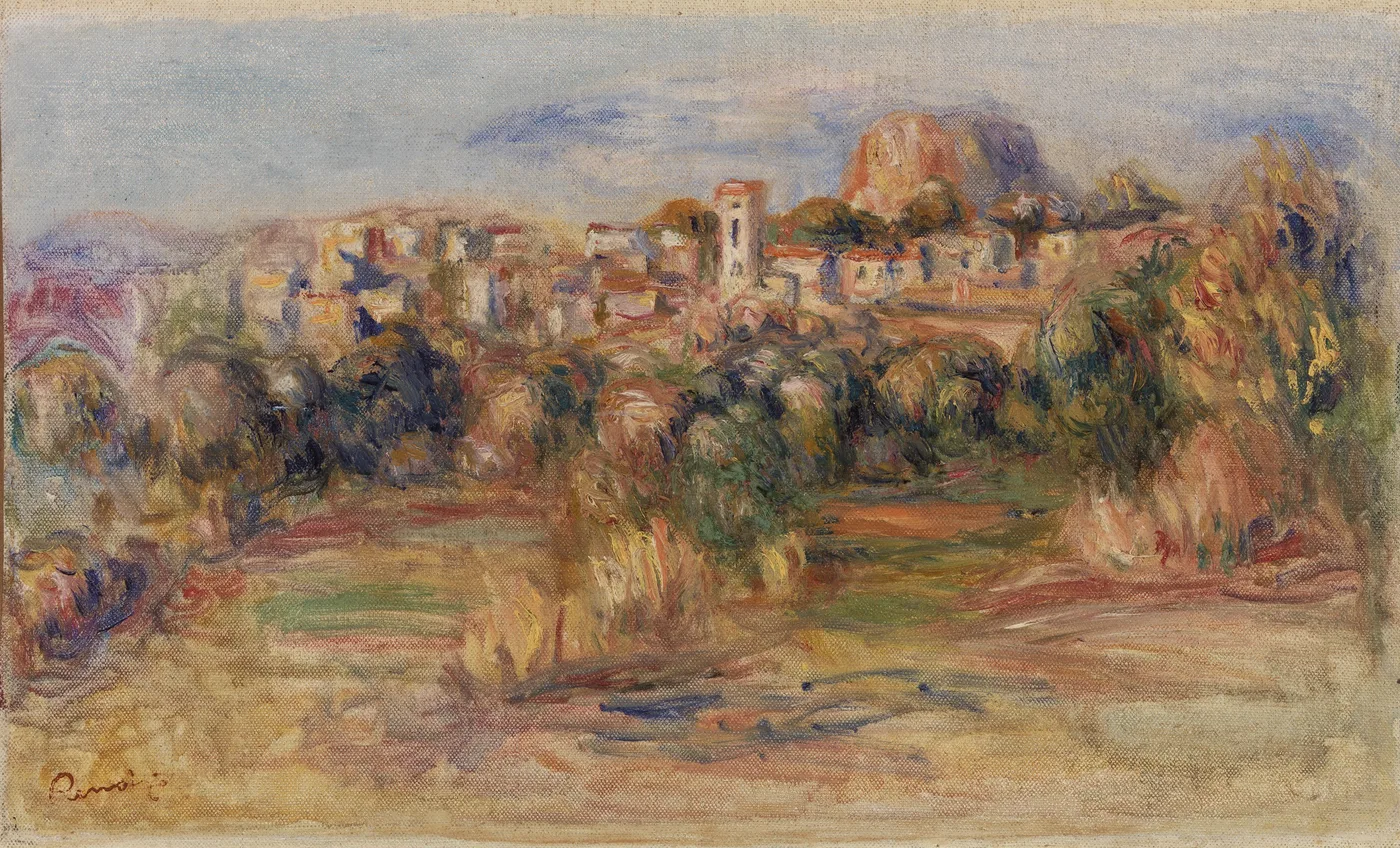 A hilltop village with a bell tower and terracotta roofs rises before a rocky outcrop under a blue sky.