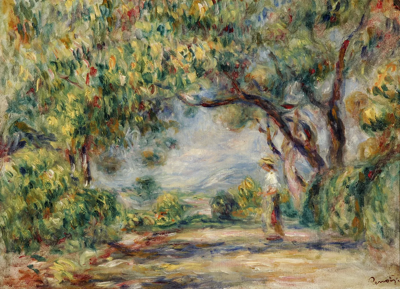 A woman in a straw hat stands beneath an archway of overhanging olive trees on a sunlit garden path.