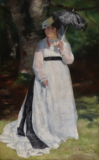 A woman in a flowing white dress holds a dark lace parasol overhead while standing in a shaded green forest