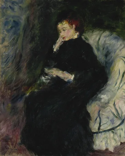 A woman in black reads in a white armchair, resting her chin on her hand, against a dark background.