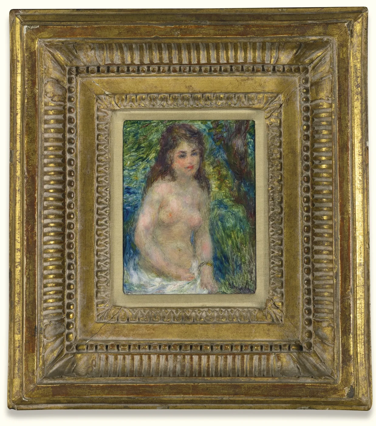 A small nude bather with long brown hair sits by a river with white cloth at her waist, amid lush green and blue foliage.