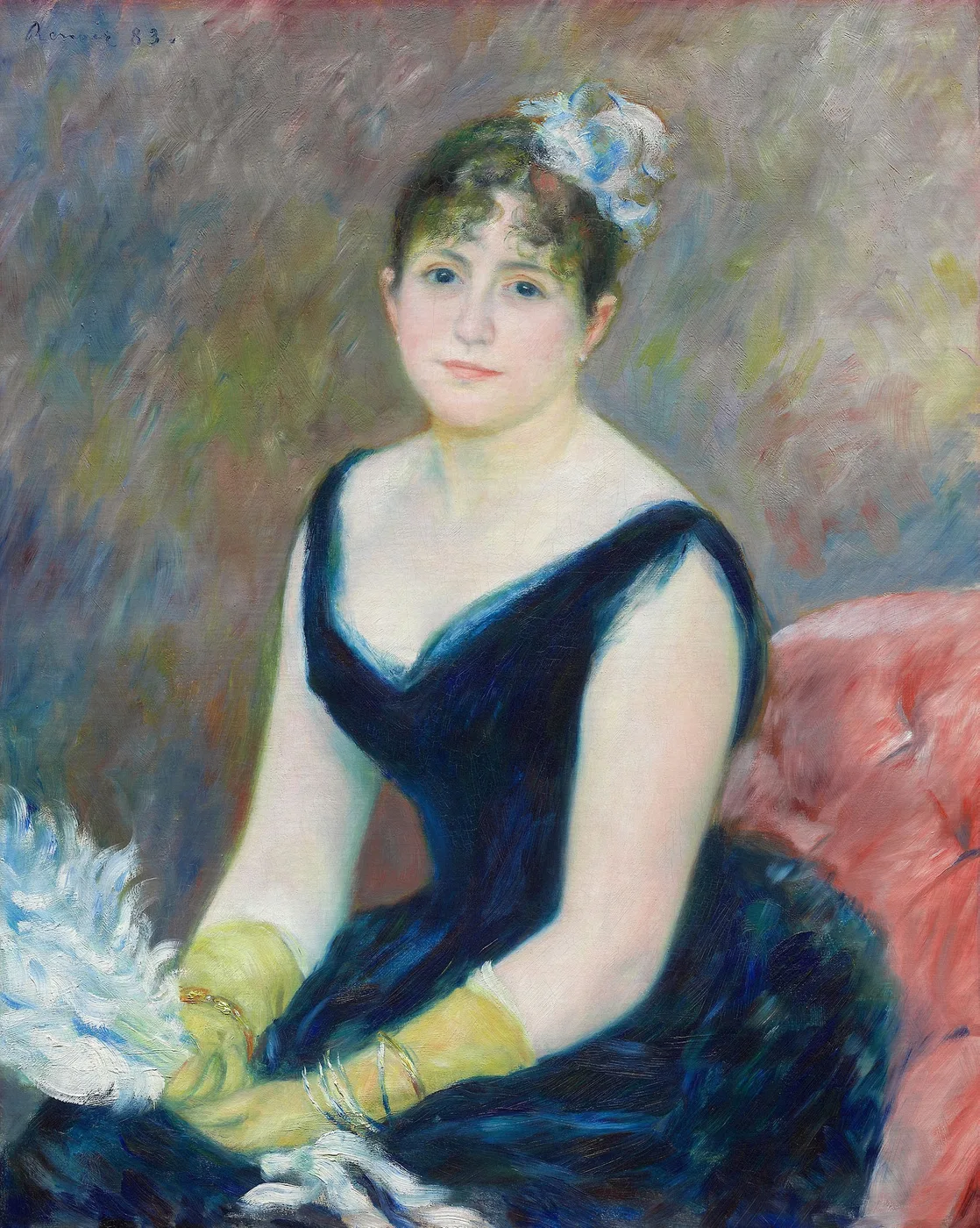 Seated woman in a low-cut dark blue velvet gown with yellow gloves, a white feather in her hair, against a pink armchair.