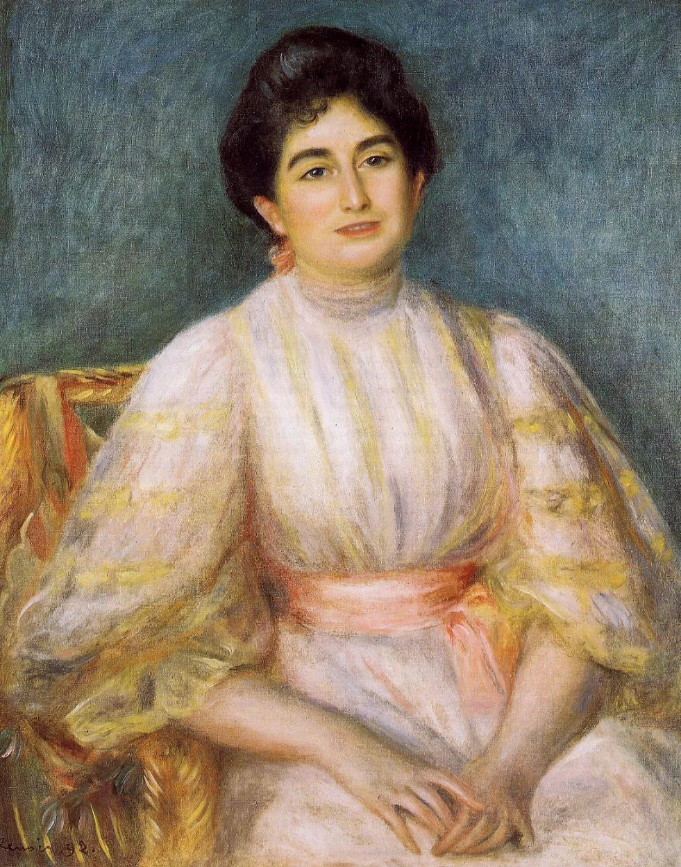 A dark-haired woman in a cream dress with a coral sash sits in a gold-striped chair, against blue-grey.