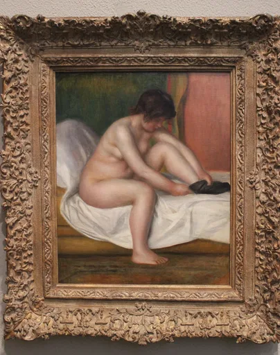 A nude woman with dark hair sits on a white sheet pulling on a black stocking, against green and pink.