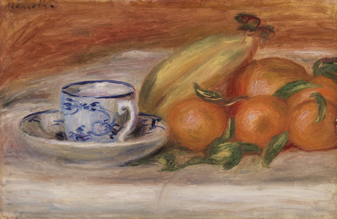A blue and white patterned teacup and saucer sit beside bananas and leafy oranges, against a warm brown background.