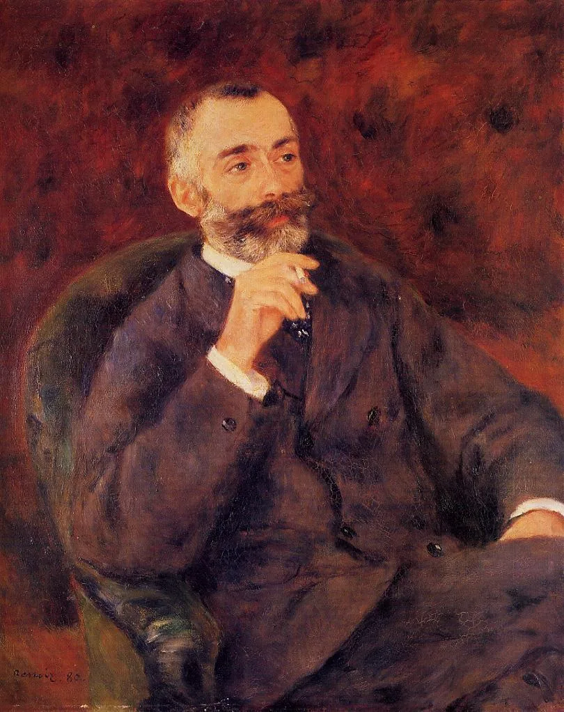 A bearded man in a dark suit sits in a green armchair, his hand raised near his chin, against a deep red background.