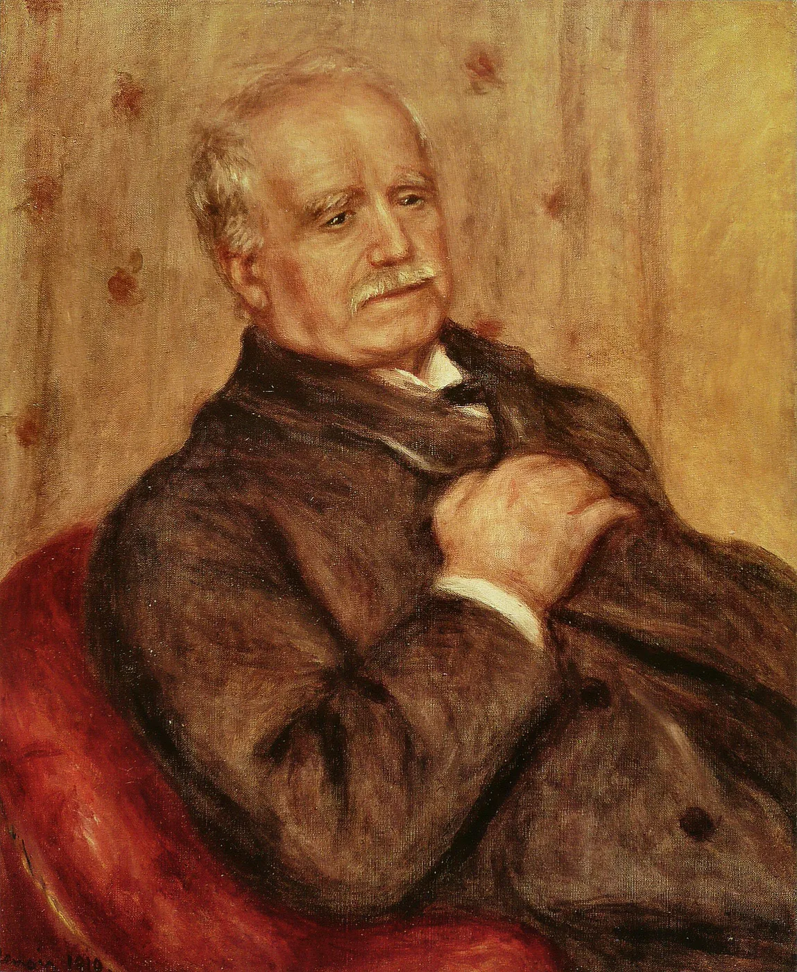 An elderly bald man with a white mustache sits in a red armchair, hands clasped, wearing a dark overcoat against a warm ochre paneled wall