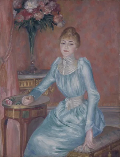 A blonde woman in a pale blue dress seated beside a table with a vase of peonies, in dusty rose, powder blue, and cream