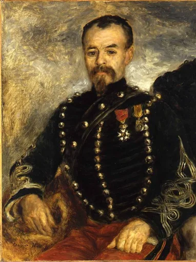 A bearded officer poses in a dark braided military jacket studded with buttons and medals, one hand resting on red fabric.