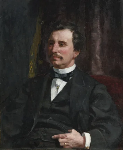 A moustached man in a black suit and bow tie sits with one hand in his waistcoat, against a dark curtained background, in black, white, and maroon tones.