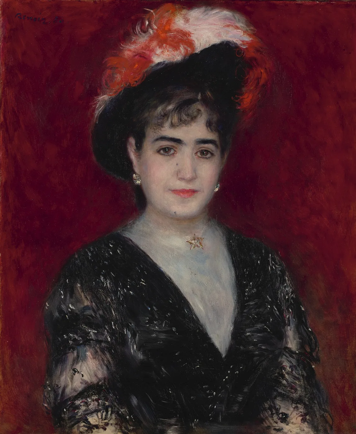 An elegant woman wears a black hat trimmed with red and white feathers and a black lace gown, against deep red.