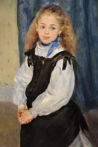 A young girl with long auburn hair and a blue ribbon at her throat wears a white blouse under a black pinafore, against a deep blue curtain