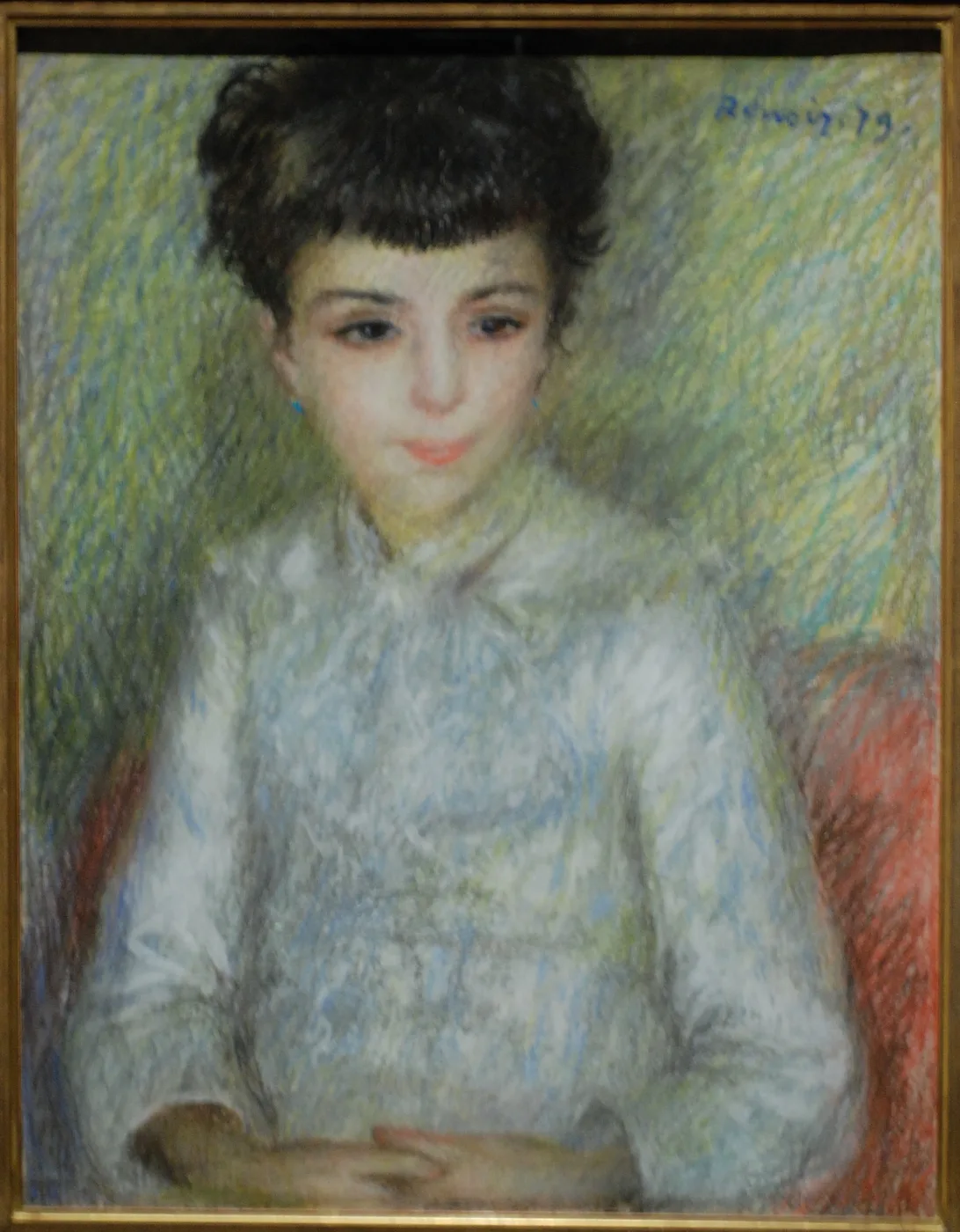 A dark-haired girl in a pale blue blouse sits with hands folded, rendered in soft pastel hatching against a green and yellow ground.