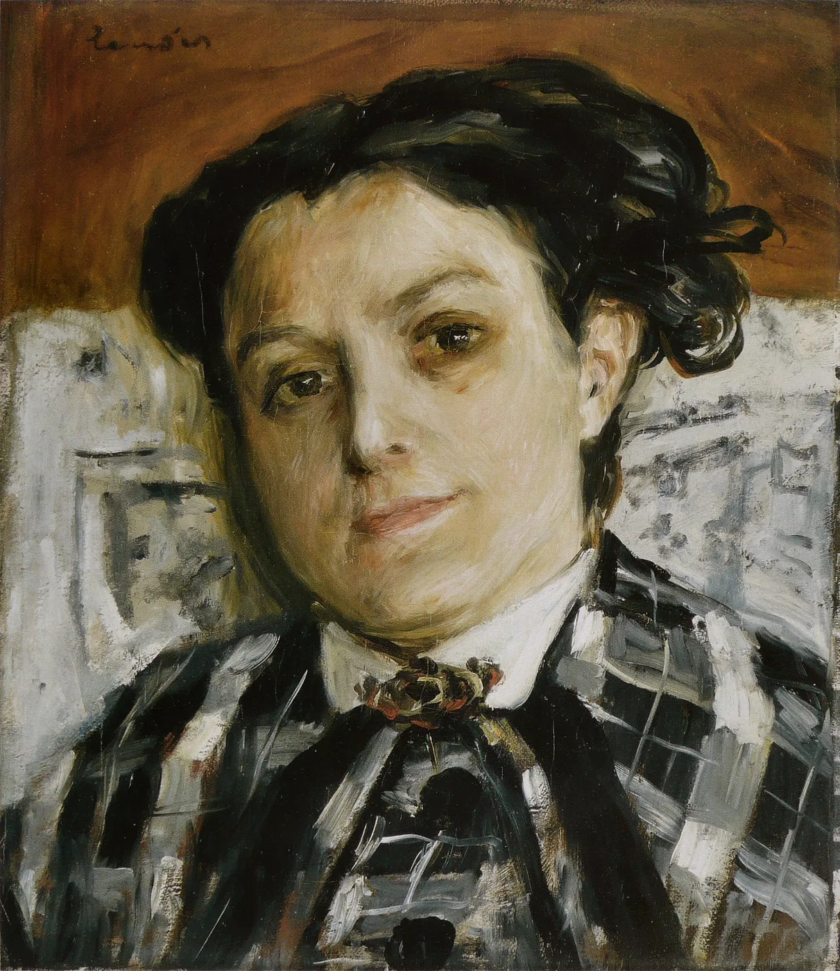 A dark-haired woman in a striped black-and-white blouse with a small brooch at her collar looks out against a rust-red and grey backdrop.