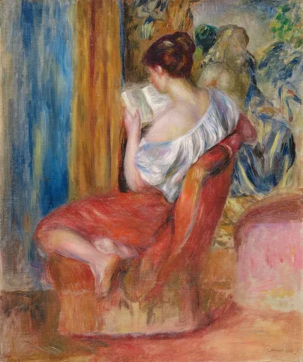 Seen from behind, a woman in a loose white blouse and red skirt reads a book curled in a red armchair, surrounded by warm interior colours.